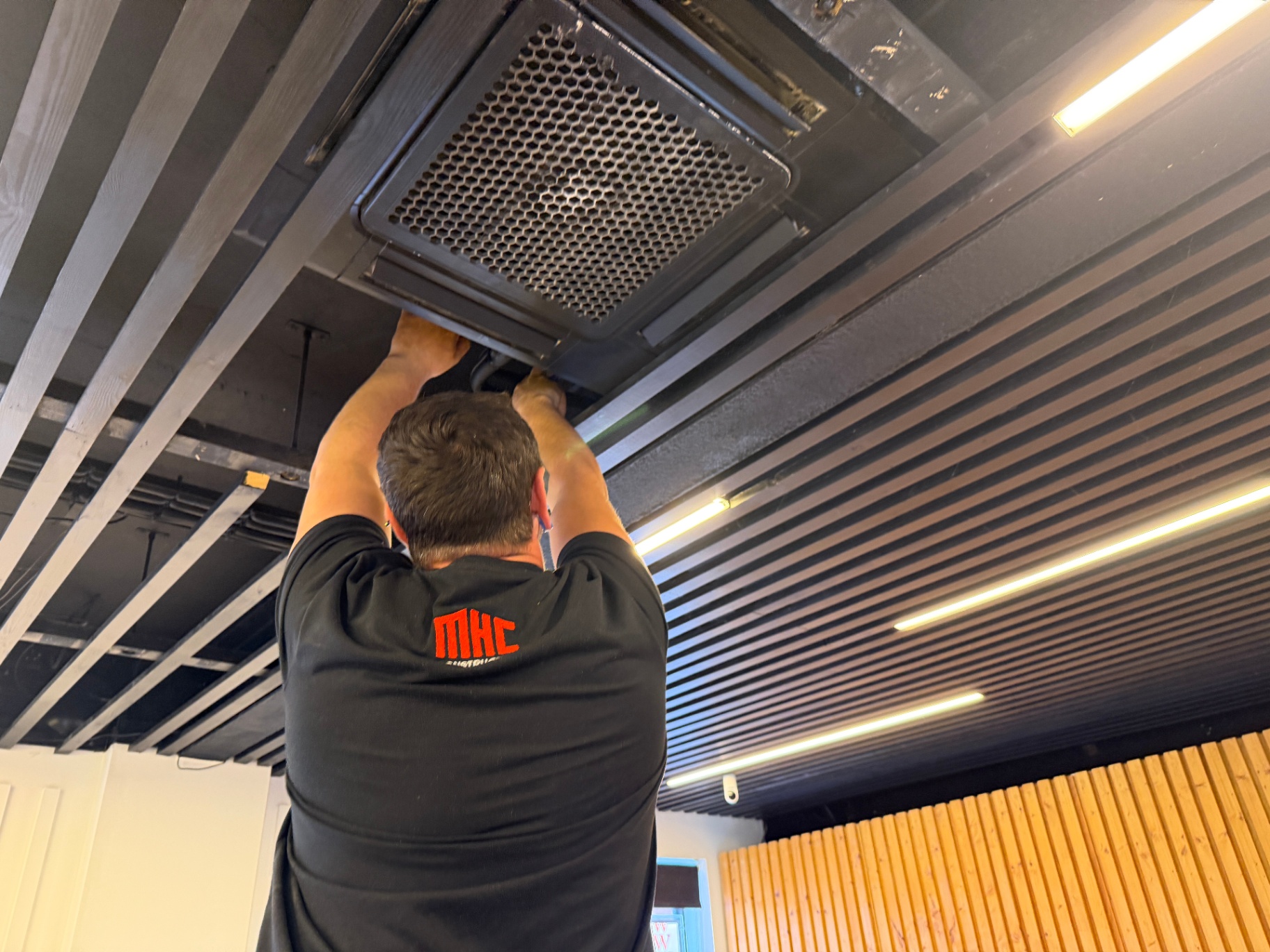 Commercial air conditioning service in a slatted-ceiling office