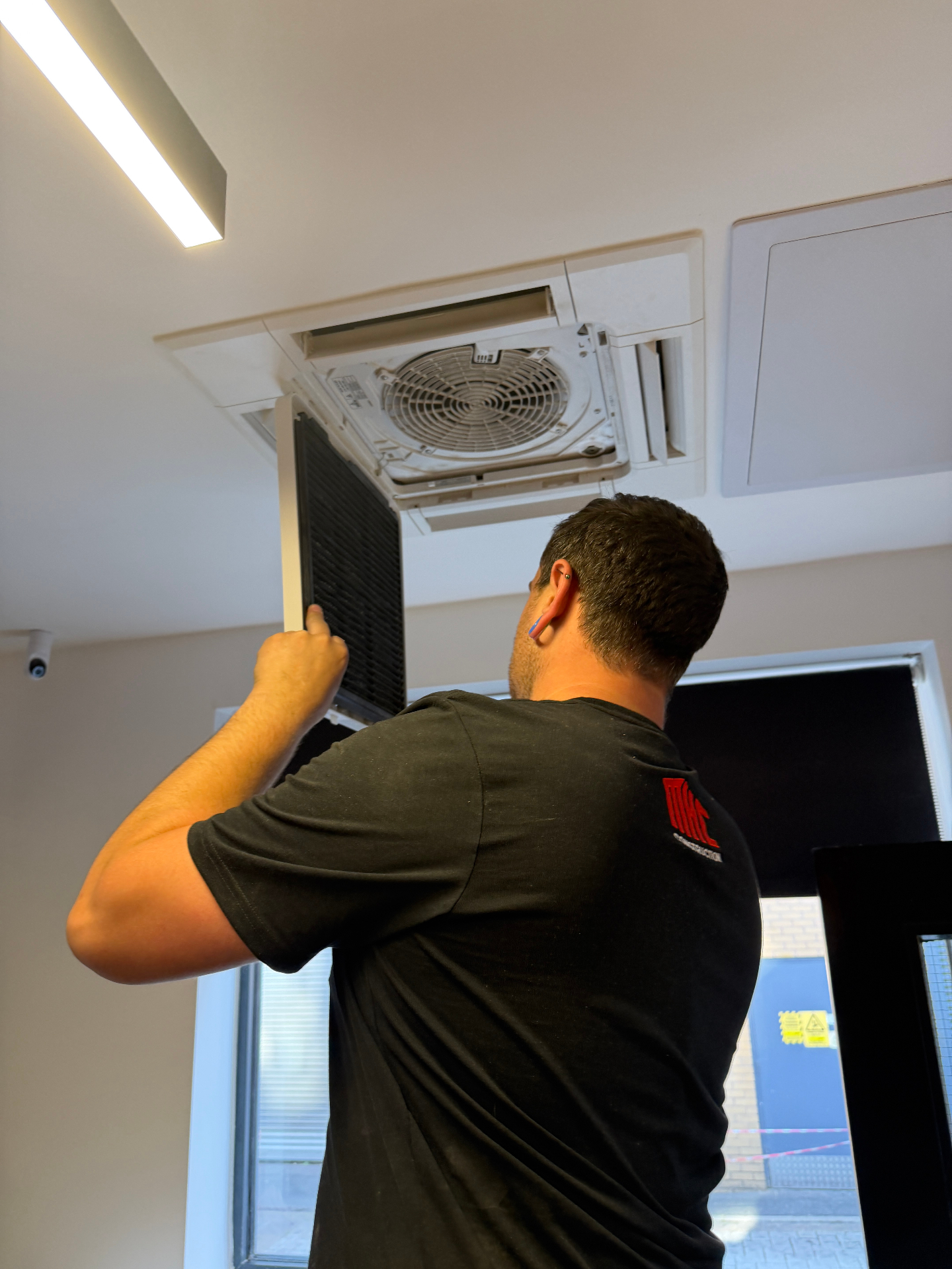 MHC engineer servicing a ceiling cassette air conditioning unit in Lincoln