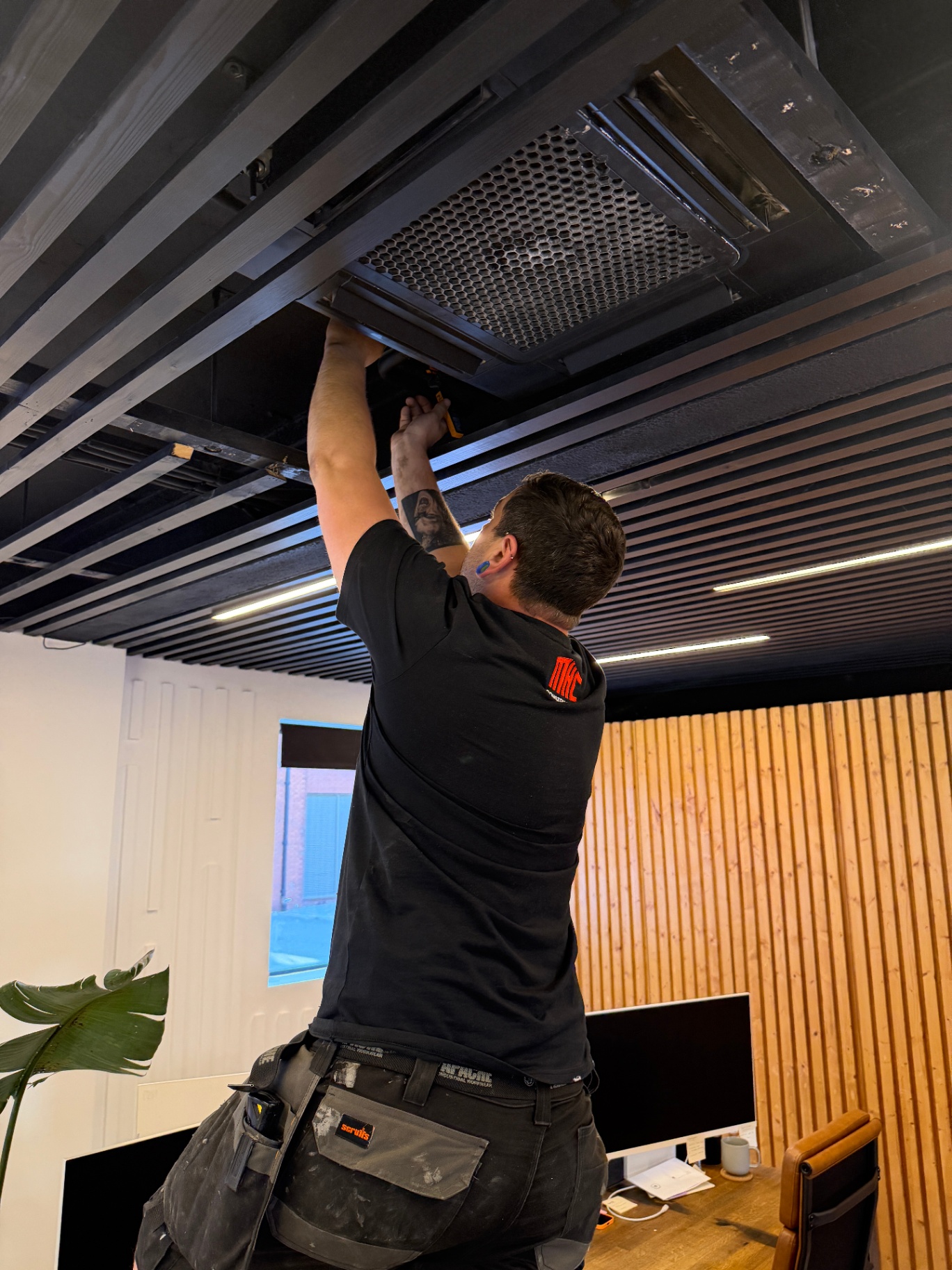 F-Gas engineer working on a Mitsubishi-style ceiling cassette